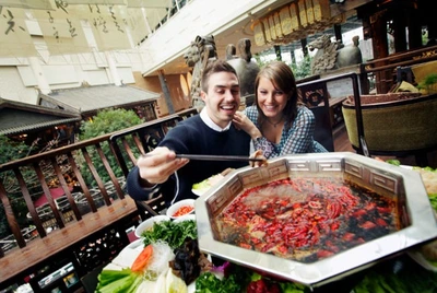Guest enjoying spicy sichuan style hotpot Guest enjoying spicy sichuan style hotpot