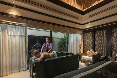 A spa therapist performs a wellness treatment at the spa facilities of Banyan Tree Samui.