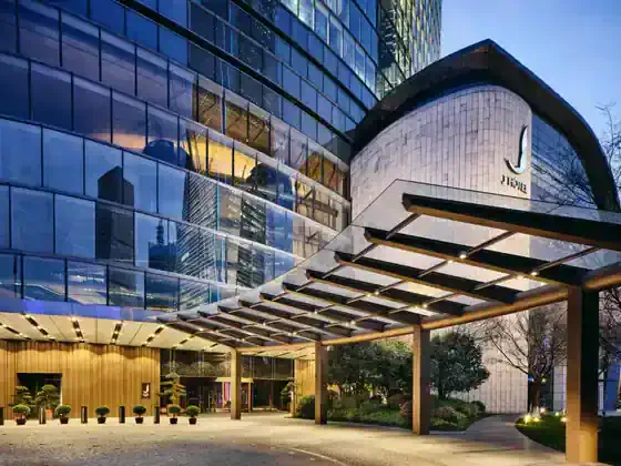 The grand entrance of J Hotel Shanghai Tower blends contemporary luxury with Shanghai-inspired design.