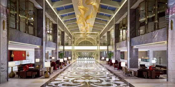 Elegant lobby at Gran Meliá Xi’an featuring high ceilings, natural daylight, and comfortable lounge seating