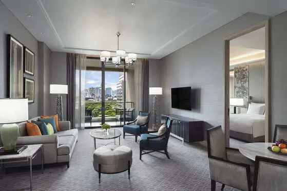 Spacious guest room with floor-to-ceiling windows at Sindhorn Kempinski Hotel Bangkok