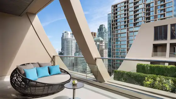 Private balcony overlooking the greenery of Sindhorn Village from Sindhorn Kempinski Hotel Bangkok