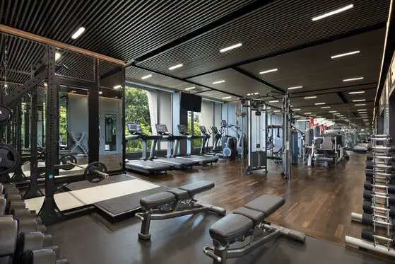 Modern fitness centre with strength and cardio equipment at Sindhorn Kempinski Hotel Bangkok