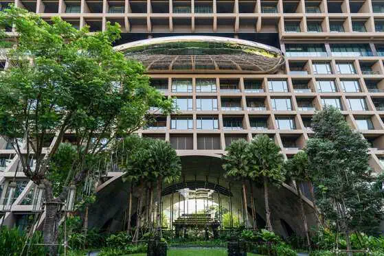 Modern architecture of Sindhorn Kempinski Hotel Bangkok viewed from the landscaped gardens