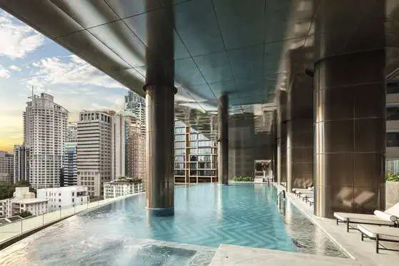 Saltwater infinity pool surrounded by greenery at Sindhorn Kempinski Hotel Bangkok
