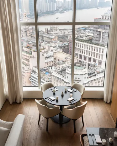 Window-side table at YONE restaurant overlooking the Bund and Huangpu River in Shanghai