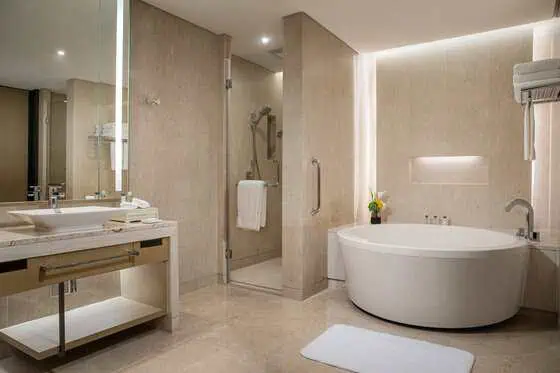 Bathtub and walk-in shower in InterContinental Wuhan suite bathroom