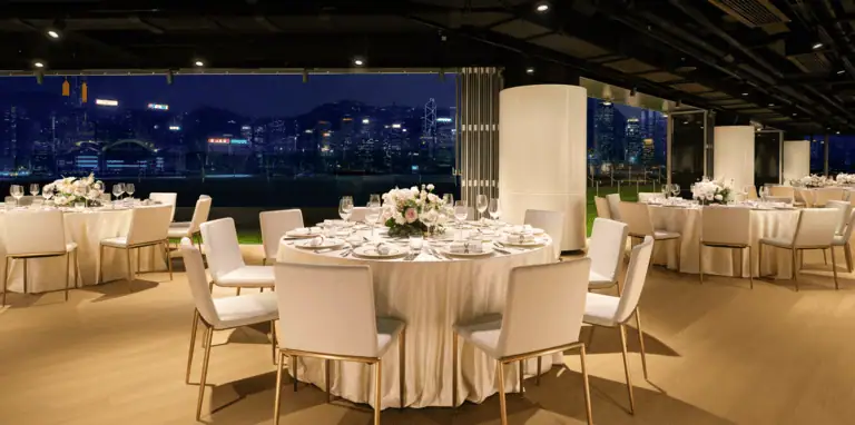 The Terrace at Regent Hong Kong with round banquet setup at night overlooking Victoria Harbour