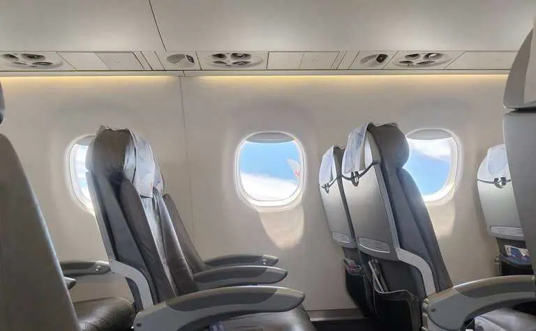 Business traveller seated in an aircraft premium cabin